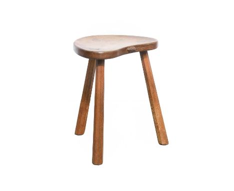 Workshop of Robert Mouseman Thompson (Kilburn): An English Oak Cow Stool, the kidney shaped seat on three octagonal legs, wit