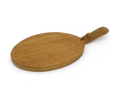 Workshop of Robert Mouseman Thompson (Kilburn): An English Oak Cheese Board, post 1960, of standard form, with carved mouse t