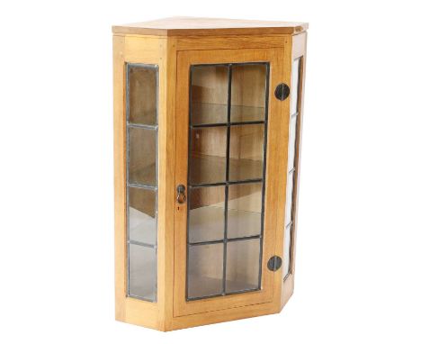 Workshop of Robert Mouseman Thompson (Kilburn): An English Oak Glazed Hanging Corner Cupboard, the leaded glazed door and sid