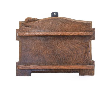 Robert Mouseman Thompson (1876-1955): An English Oak Pipe Rack, with five holders, shaped square back with carved mouse trade