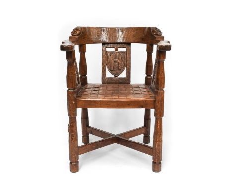 Robert Mouseman Thompson (1876-1955): An English Oak Monk's Chair, circa 1930s, with curved back and shaped arms, each side c