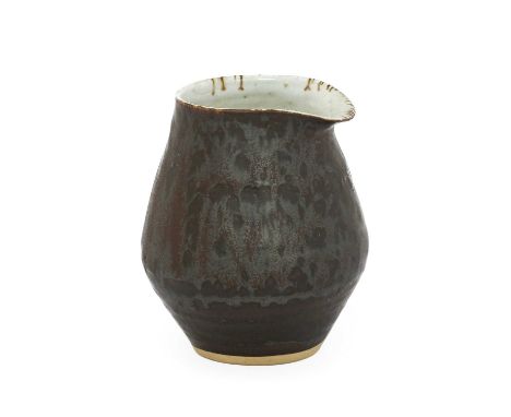 Lucie Rie (1902-1995): A Stoneware Pouring Vessel, manganese glaze and pitted oatmeal interior, impressed LR seal,7.5cm high 