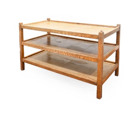 Robert Mouseman Thompson (1876-1955): An English Oak Dinner Wagon Tea Trolley, three tiers with raised sides, joined by four 