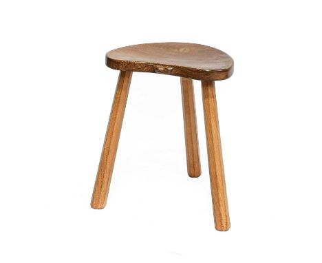 Workshop of Robert Mouseman Thompson (Kilburn): An English Oak Cow Stool, the kidney shaped seat on three octagonal legs, wit