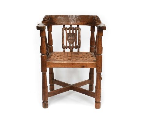 Robert Mouseman Thompson (1876-1955): An English Oak Monk's Chair, circa 1932, with curved back and shaped arms, each side ca