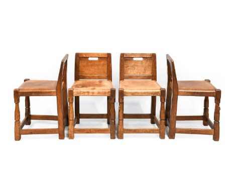 Robert Mouseman Thompson (1876-1955): A Set of Four English Oak Low Panel Back Chairs, circa 1930s/40s, with aperture to pane