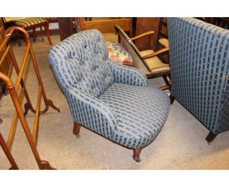 An Edwardian upholstered and button back armchair