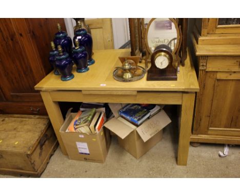 A light oak extending dining table with two extra leaves