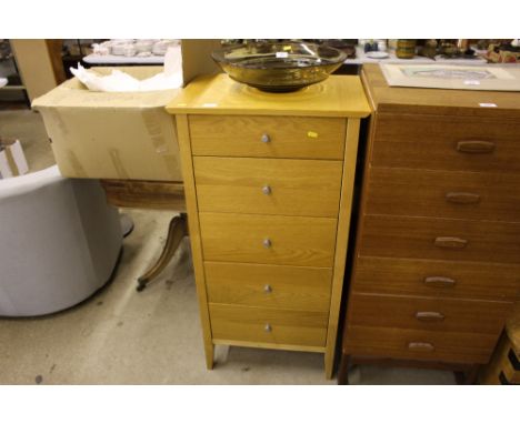 A light oak five drawer chest of narrow proportions
