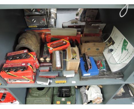 A shelf of mixed gauge Accessories and Rolling Stock, some boxed along with empty boxes and a part built Steam Model