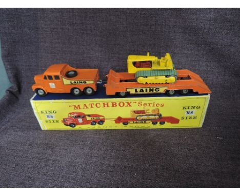 A Matchbox Lesney King Size diecast, K-8 Tractor and Transporter having Laing decal, in orange with yellow tractor, in origin