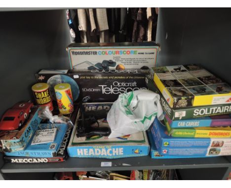 A shelf of mixed vintage Toys including Opticraft Telescope, Meccano, Headache, card Jigsaws, Airfix plastic Datamatic Car et