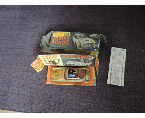 A Corgi diecast, 261 James Bond's 007 Aston Martin DB5 on inner card display stand with driver and bandit present, paper inst