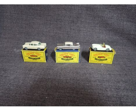 Three Matchbox Moko Lesney diecasts, No 19 MG A Sport Car, No 22 Vauxhall Cresta in pink and No 27 Cadillac in mauve with lig