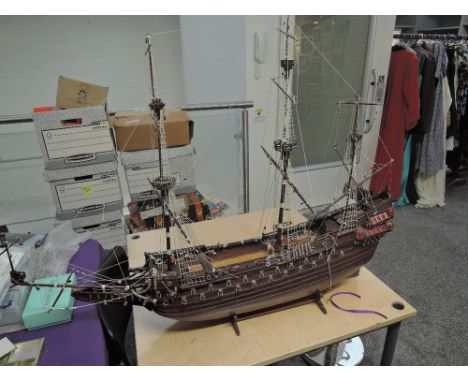 A wooden scale model Galleon having extensive rigging and cannon decoration, on wooden stand length 100cm, height 75cm