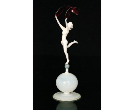 A 20th Century Istvan Komaromy lampworked glass figure of a female nude in dancing pose with arms raised holding a scarf, set
