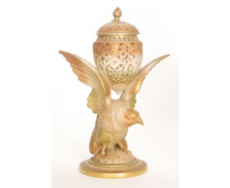 An early 20th Century Royal Worcester reticulated pot pourri and cover in the form of an egg with a band of cherub heads to t