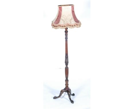 An early 20th Century Chippendale style mahogany standard lamp and shade with reeded column on tripod legs and paw feet, heig