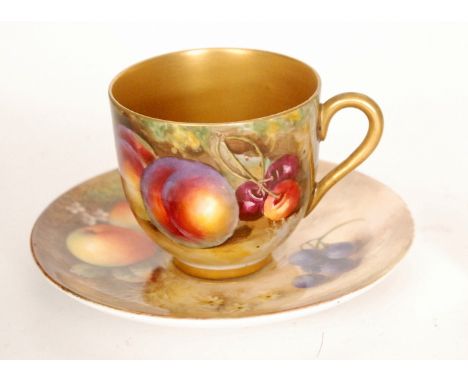 A matched Royal Worcester Fallen Fruits cabinet cup and saucer the saucer decorated by Seabright with hand painted apples and