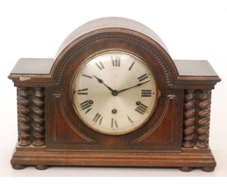 A 1920s oak cased pillared mantle clock with eight day striking movement on a gong, width 48cm
