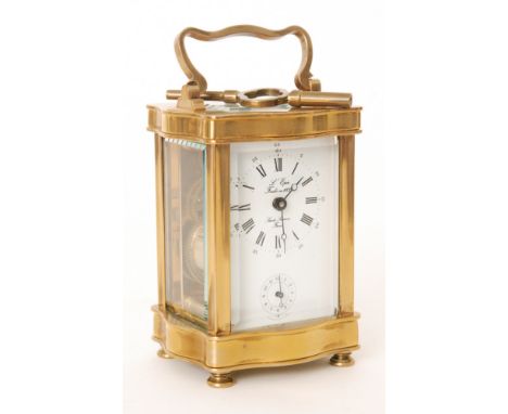 A 20th French brass carriage clock of cartouche form with white enamelled dial incorporating a subsidiary dial, the dial sign
