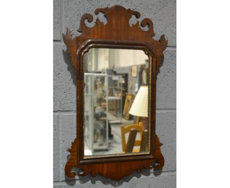 A Chippendale style mahogany fret carved wall mirror, height 57cm