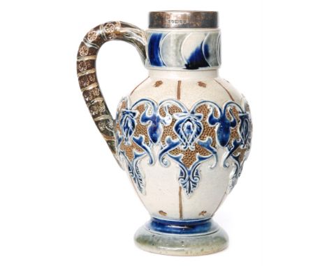 A late 19th Century Fulham Pottery stoneware jug designed by C.J.C Bailey decorated with a relief moulded and impressed band 