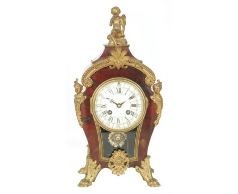 A late 19th to early 20th Century French mantle clock, with cherub finial and decorative gilt metal mounts, the un-named move