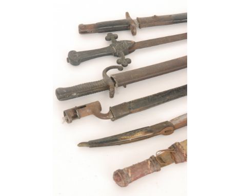 A 19th Century saw back bayonet, a socle bayonet, another similar, a short sword and scabbard and two daggers (6)