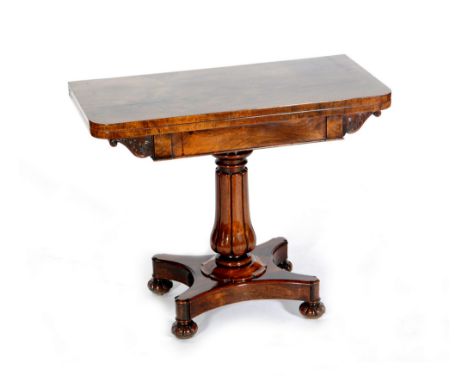 A William IV rosewood rectangular fold over card table on a fluted baluster pedestal, on a quatrefoil plinth base with turned