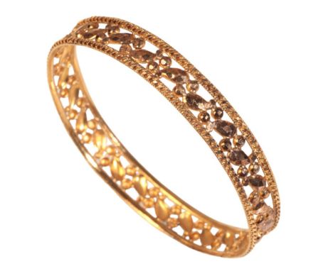 A 22CT GOLD BANGLE of Filigree design work, 10mm width, 6.2cm diameter, set in original box "Hemachandra Bros. jewellers. Col