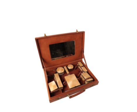 AN ELIZABETH II ENAMELLED SILVER SEVEN PIECE DRESSING SET by Goldsmith's & Silversmith's Company, London 1948, with guilloche