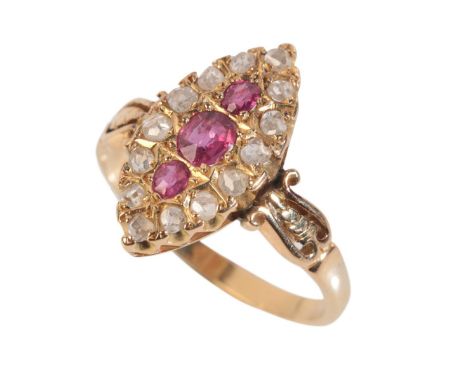 A DIAMOND AND RUBY RING the oval face set with three graduated rubies, the largest approx 0.2ct, within a border of fourteen 