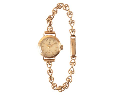 TUDOR: A LADY'S 9CT GOLD BRACELET WATCH with manual wind movement, the cream dial with subsidiary seconds dial, gold baton nu