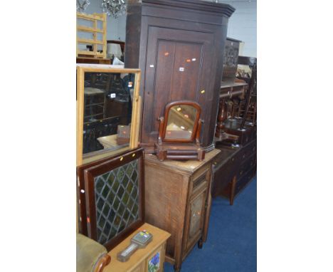 A GEORGIAN OAK PANELLED SINGLE DOOR CORNER CUPBOARD, together with a Victorian swing mirror, two window lights and a baromete