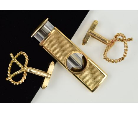 TWO ITEMS TO INCLUDE, a 9ct gold cigar cutter, engine turned, measuring approximately 52mm x 17mm, hallmarked 9ct gold, Birmi
