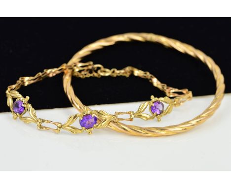 A BANGLE AND A 9CT GOLD AMETHYST BRACELET, the hollow bangle of a twisted design, stamped 375, inner diameter 62mm, the brace