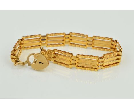 A LATE 20TH CENTURY 9CT GOLD GATE BRACELET, four bar straight design, measuring approximately 180mm in length, fitted to a pa