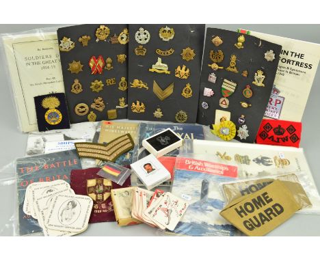 A LARGE BOX CONTAINING DISPLAYS ON CARD OF BRITISH MILITARY CAP BADGES, SHOULDER TITLES, etc, WWI/WWII era, over thirty in to