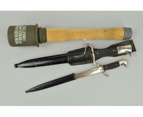 A REPRODUCTION WWII GERMAN STICK GRENADE, together with a WWII German Officer Fire Service dagger with scabbard and leather f