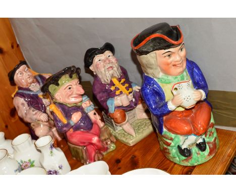 A STAFFORDSHIRE TOBY JUG, holding a jug, height approximately 23cm, together with three Melba Ware toby jugs (4)