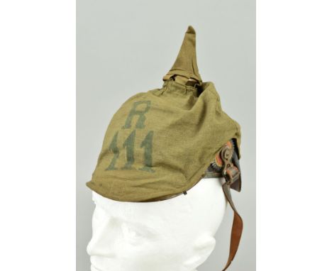 A WWI IMPERIAL GERMAN ARMY PICKELAUBE HELMET, complete with leather visor, strap, inner and metal cockade side trims, the hel
