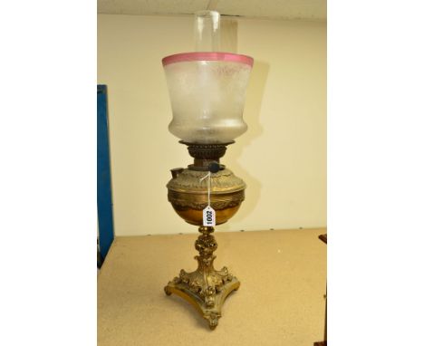 A BRASS OIL LAMP, on trefoil base, with glass funnel and etched shade, approximate height base 42cm