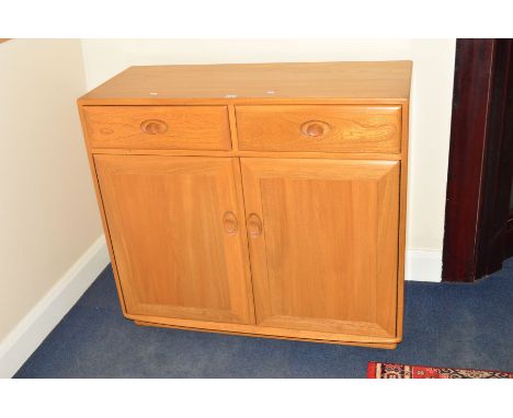 AN ERCOL ASH SIDEBOARD, with two drawers and double cupboard doors, width 104.5cm x depth 44cm x height 93.5cm