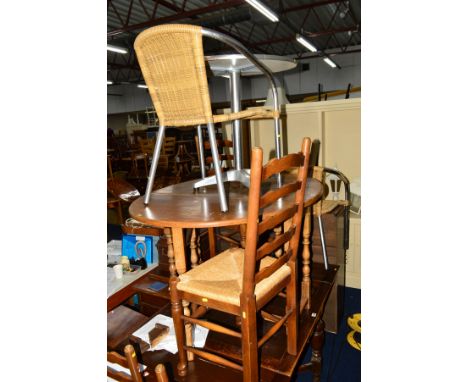 AN OAK DROP LEAF DINING TABLE, four rush seated ladder back chairs, a round stainless steel garden table with two matching ch