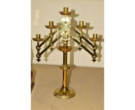 A VICTORIAN BRASS GOTHIC ECCLESIASTICAL FIVE LIGHT CANDELABRUM, with screw fitting to adjust angle of both arms, on a knopped