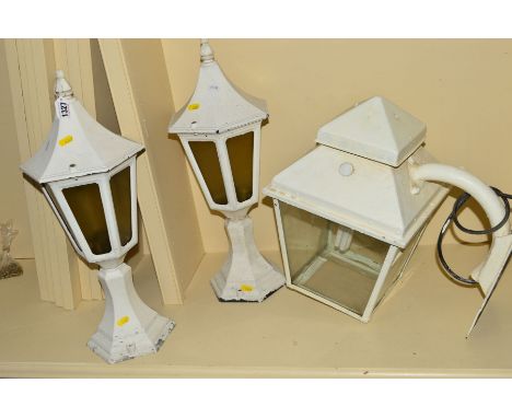 A WHITE PAINTED WROUGHT IRON WALL MOUNTED LANTERN together with a pair of pillar top lanterns (3)