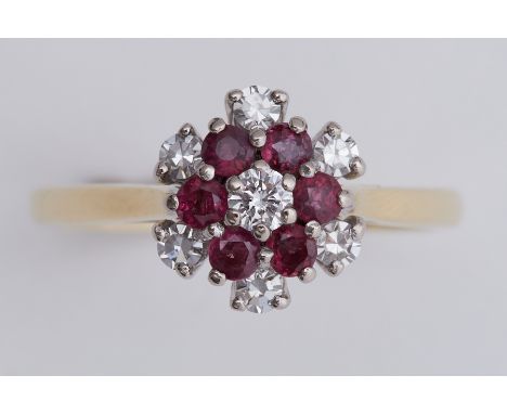 An 18ct yellow &amp; white gold flower design cluster ring set with diamonds &amp; rubies, total diamond weight approx. 0.28 