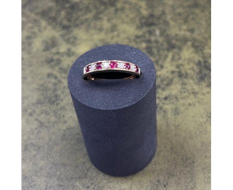 An 18ct yellow gold diamond and ruby half eternity ring, size P/Q.