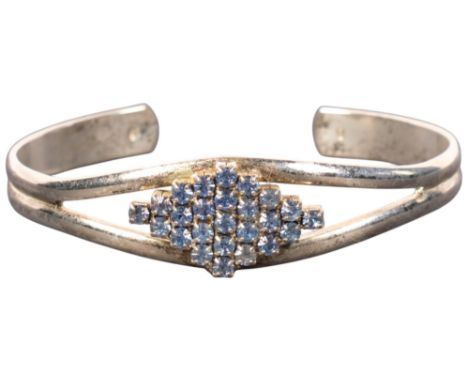 A modern white metal blue paste cuff bangle, 18.1gNo damage or repair, all stones present, marked 750 but definitely not gold